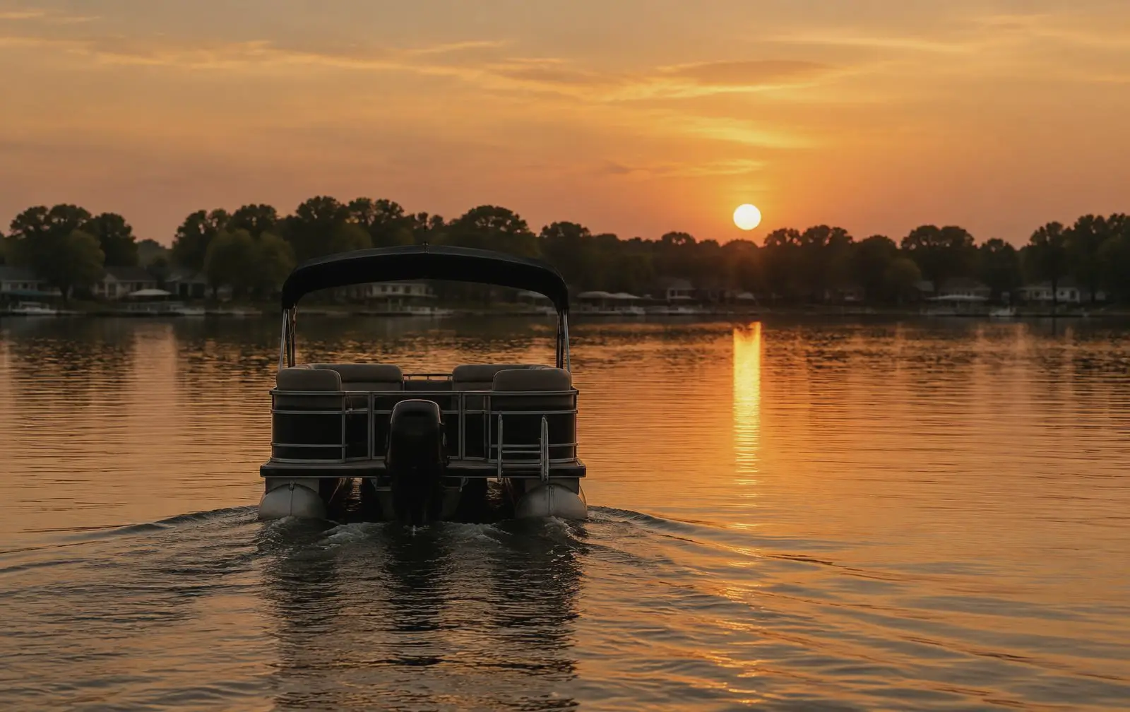 Pontoon boat silhouetted at sunset